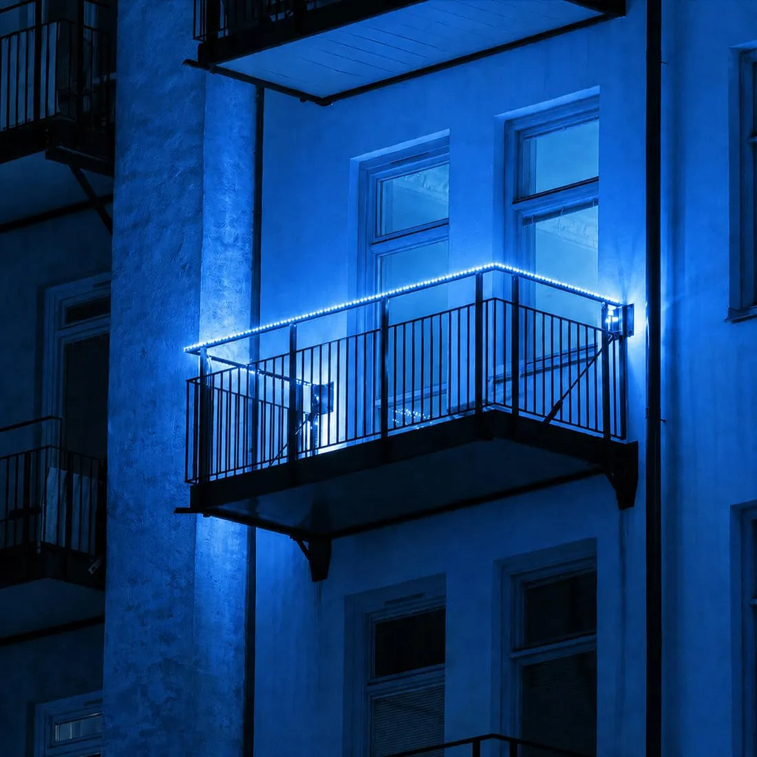 Blue LED rope lighting following the edge of a balcony railing